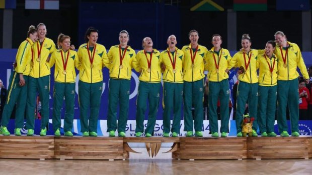 Winners are grinners: The Australian team sings the national anthem on the victory podium.
