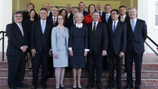 Who's who? ... Governor-General Quentin Bryce poses for photos with Prime Minister Julia Gillard and her new-look ministry after the swearing-in ceremony at Government House.
