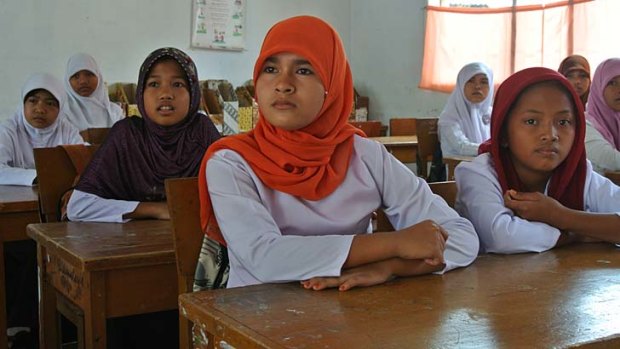 Uphill battle: Children at school in northern Padang, Indonesia, are ignorant about what to do in an earthquake despite the 2009 disaster.