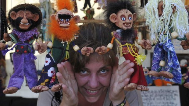 Sara Lee, of Byron Bay, selling her handmade marionettes at "The Squeaking Tribe" stall News. Thursday is set up day at the National Folk Festival.