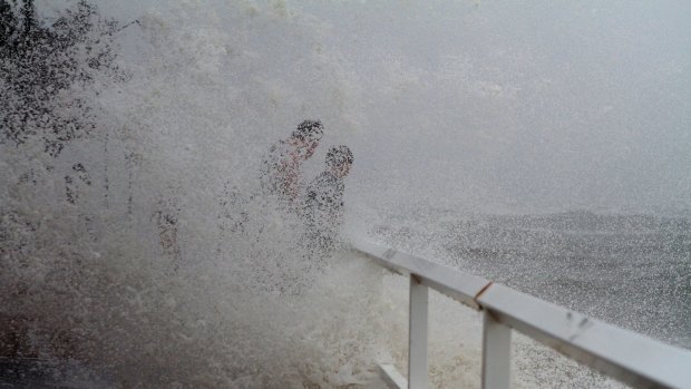 Locals at Shorncliffe Pier during cyclonic conditions.