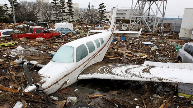 Near the city’s airport, cars and planes were strewn like toys among the debris.