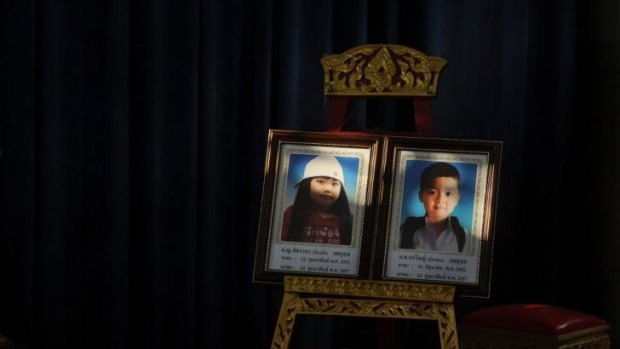 Portraits of  blast victims Patcharakorn Yosubon and her brother Koravitch Yosubonis placed at a Buddhist temple for last rites in Bangkok.