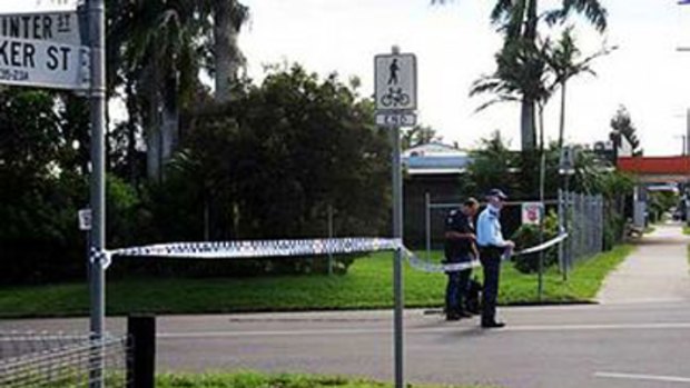 Police guard the taped-off area near the family home in Bundaberg.