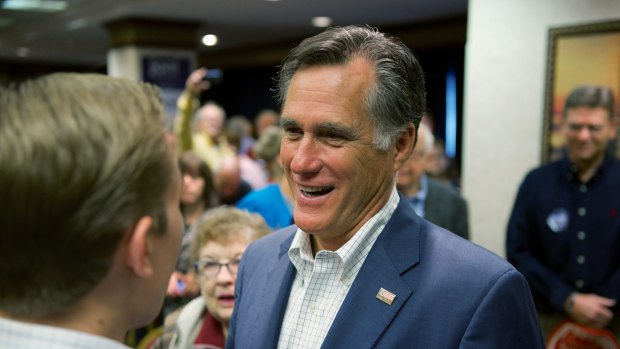 Mitt Romney greets supporters at a campaign function for US Senate candidate Joni Ernst.