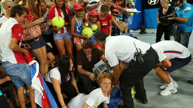 The hoarding holding the crowd back collapsed on Djokovic's legs in the process.