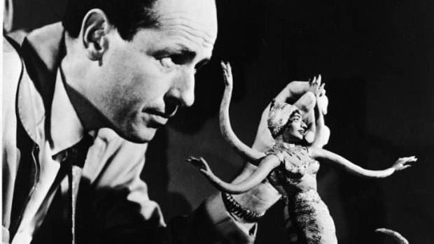 Ray Harryhausen manipulates a figure of a serpent-like monster for stop motion animation, circa 1965.