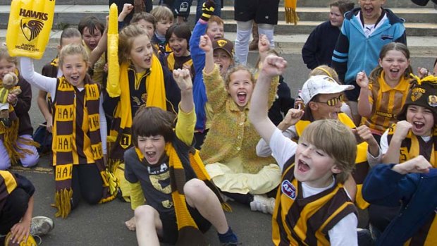 Hawks fans at Balnarring Primary School give the grand final parade a dry run.