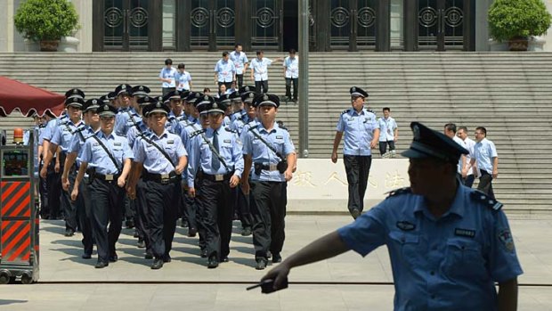 Fall of a high-flyer: Police close ranks around the courthouse where  disgraced politician Bo Xilai will go on trial.