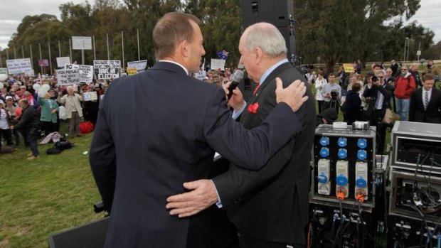 Tony Abbott and Alan Jones embrace at an anti-carbon tax rally in Canberra in August 2011.
