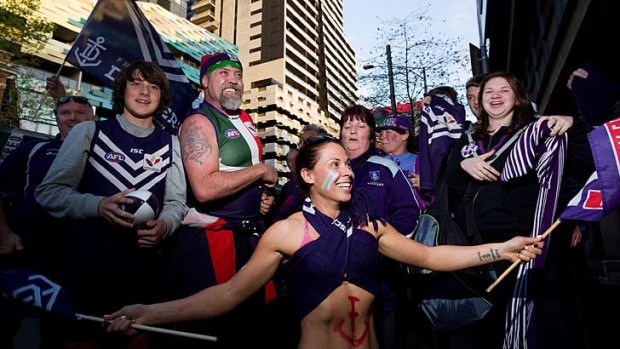 Fremantle Dockers supporters arrive at Southern Cross bus terminal