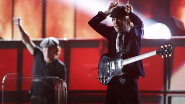 Angus Young of AC/DC puts on 'horns' during the Grammys show.