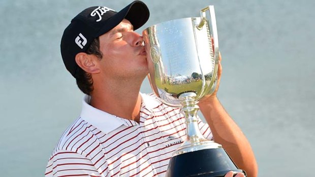 Daniel Popovic kisses the trophy after his win in the Australian PGA.