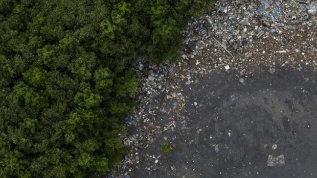 This aerial view shows the littered shore of a water channel that flows into the Guanabara Bay in Rio.