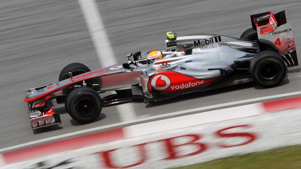 Lewis Hamilton speeds down the straight during the second practice session at the Sepang International Circuit.