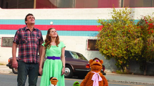 Gary (Jason Segel), Mary (Amy Adams), new Muppet Walter, Kermit the Frog and Fozzie Bear search for Gonzo the Great in <i>The Muppets</i>.