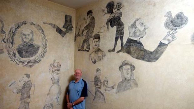 Dating back to the 1880s... Keith Sutton with the murals that were uncovered on the living room walls of his Petersham home.