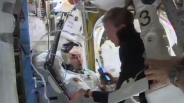 NASA footage shows astronaut Karen Nyberg (right) helping astronaut Luca Parmitano (left) remove his space suit after the aborted spacewalk on July 16, 2013.