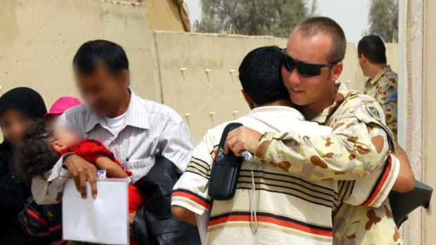 A member of the Australian Defence Force says goodbye to an Iraqi interpreter.