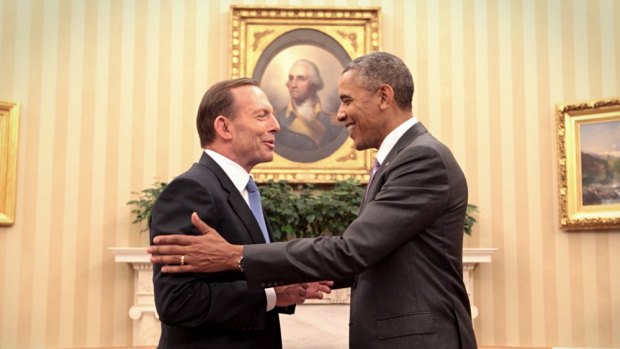 Shaking on it: Abbott and Obama agree to step up defence agreements as the Iraq crisis looms.