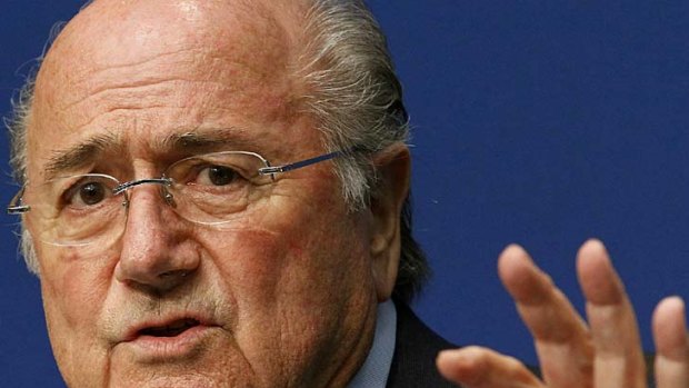 Sepp Blatter's position as head of world football is under fire  after he said that disputes on the pitch involving racist abuse should be resolved by a handshake.