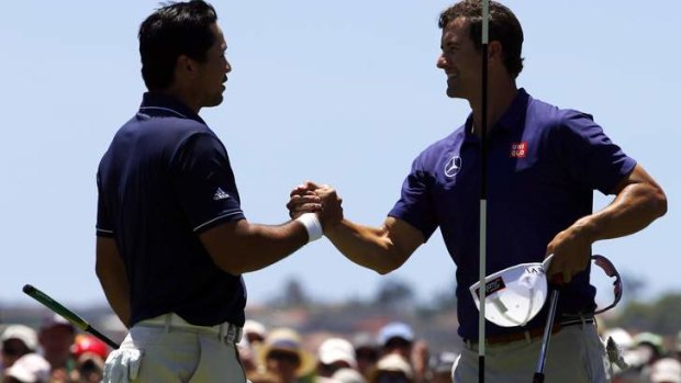 Jason Day shakes hands with Adam Scott after they finished their first rounds.