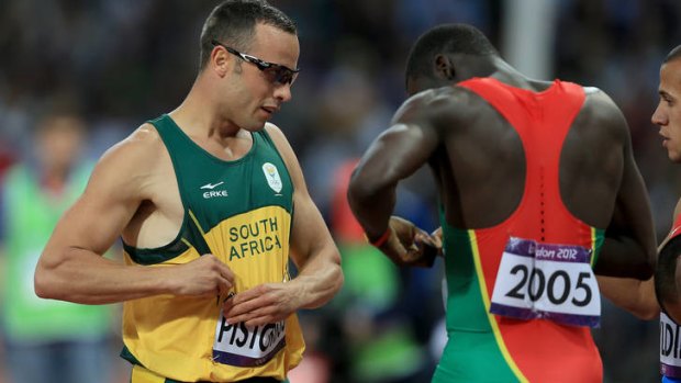 Mutual respect ... South Africa's 'Blade Runner' Oscar Pistorius exchanges numbers with world champion Kirani James after failing to qualify from the 400m semi-final.