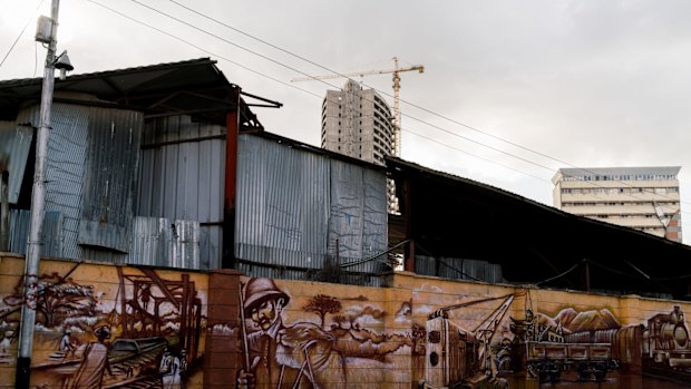 Scenes from the construction of the 20th century British railway known as the Lunatic Express are painted on a wall outside the Railway Museum in Nairobi, Kenya.