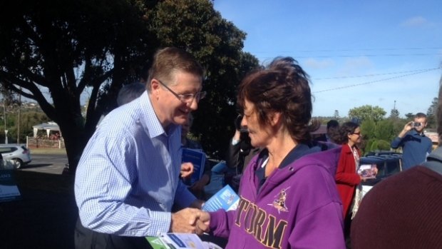 Premier Denis Napthine greets a voter at Drill Hall voting booth in Portland.