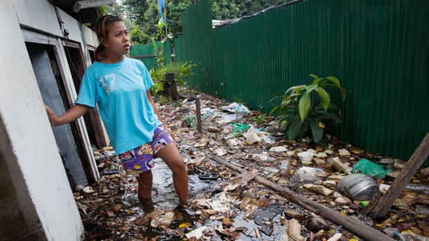Nym stands in floodwater near her home in Bangkok.