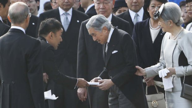 Under fire:  Taro Yamamoto hands  a letter to Japan's Emperor Akihito as Empress Michiko  looks on during the autumn garden party at the Imperial Palace.
