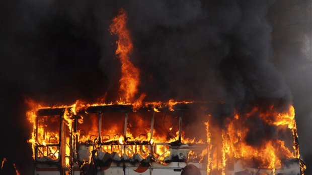 A bus on fire after alleged gang members attacked it in Rio de Janeiro.