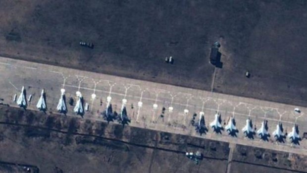 Satellite images of Russian SU-27/30, SU-24 and MiG-31 fighter jets sitting on the tarmac at Buturlinovka Air base, 150 km from the Ukainian border. The Pentagon described the low altitude passes by a Russian fighter pilot over a US warship as 'provocative and unprofessional'.