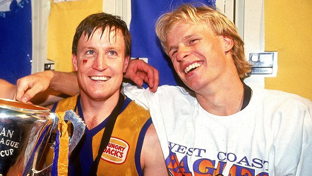 Worsfold and Kemp pose with the premiership trophy after winning the AFL Grand Final match in 1992.