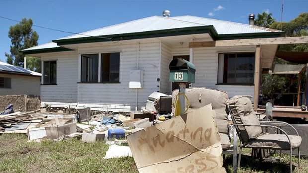 A house in Mitchell with a sign alerting volunteers it is awaiting insurance assessment.