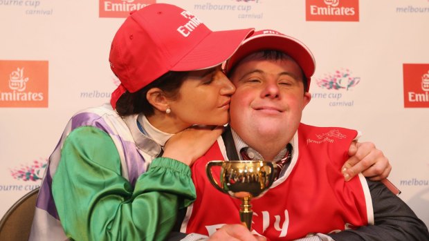 Michelle Payne celebrates her winning ride with brother and strapper Steven Payne.