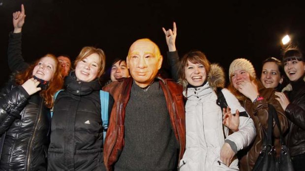 Mood for change ... people pose with a protester in a Vladimir Putin mask during a rally in St Petersburg.