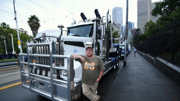 Logging trucks parked around state Parliament to protest the closure of the Heyfield Timber Mill. 