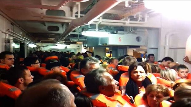 Passengers and crew members as they prepare to evacuate the Costa Concordia.