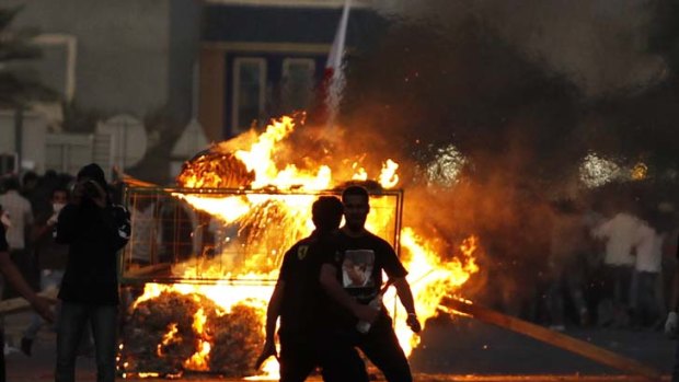Protesters clash with riot police after the funeral procession for Fadhel Mirza near Manama.
