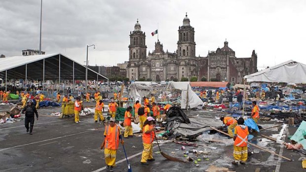 Strikers cleared: City workers begin to clean up the Zocalo.