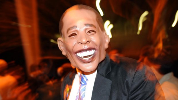 A man wearing a mask of Senator Barack Obama attends the West Hollywood Halloween costume carnival.