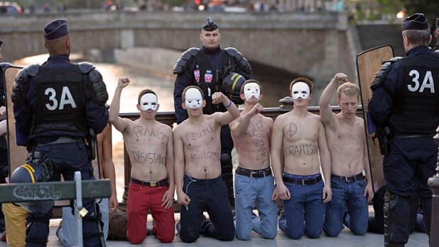 Men in masks: A protest in Paris on Friday against legalising same-sex marriage.