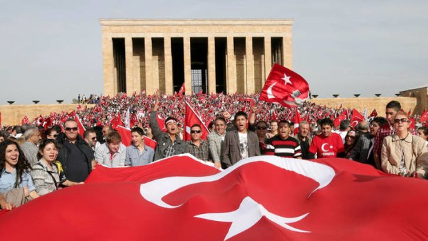 Thousands of people holding national flags gather at the Ataturk mausoleum to celebrate Republic Day and demand the government uphold secular traditions.