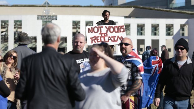 Aboriginal Tent Embassy caretaker Roxley Foley behind the crowd at the Reclaim Australia rally.  