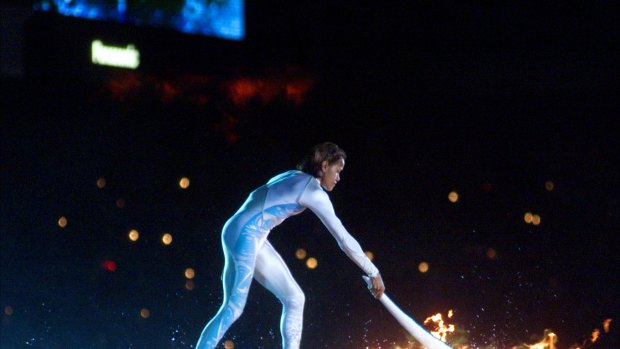 Australian Olympic athlete Cathy Freeman ignites the Olympic flame during the opening ceremony for the Summer Olympics.