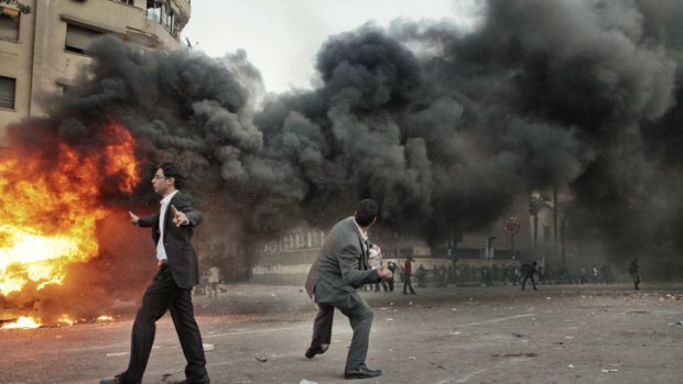 Protesters clash with police in Tahrir Square, nine days before the scheduled elections.