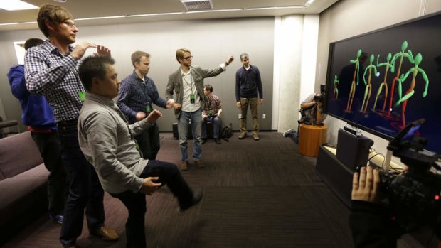 Motion slickness: Journalists test the improved motion-detection capabilities of the Xbox One's Kinect controller.