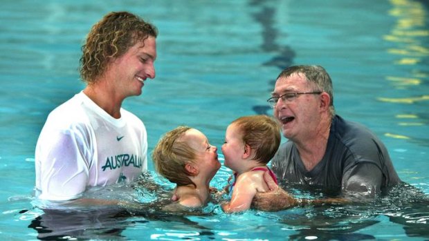 Swimmer Justin Norris with son Coda and Laurie Lawrence with grand-daughter Evie Reid.