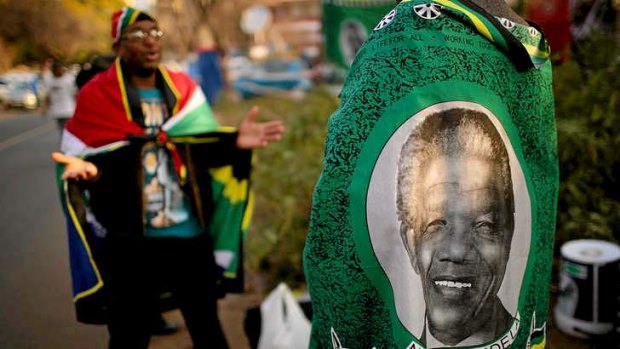 Street vendors sell souvenirs outside the hospital where Mandela has been since June 8.
